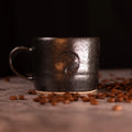 Handmade tea mug with handle by Matthew Jones, finished in a deep, glossy glaze with subtle speckling. Big Dog Coffee