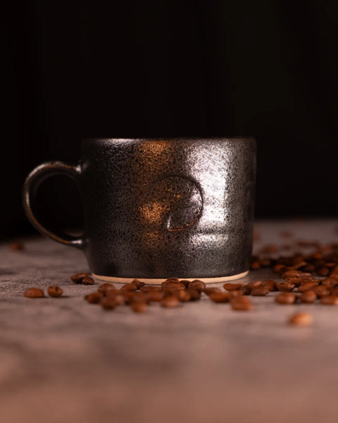 Handmade tea mug with handle by Matthew Jones, finished in a deep, glossy glaze with subtle speckling. Big Dog Coffee