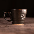 Handmade latte cup with handle by Matthew Jones, finished in a deep, glossy glaze with subtle speckling. Big Dog Coffee