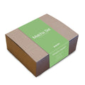 Matcha set packaging with green label on a white background by Big Dog Coffee